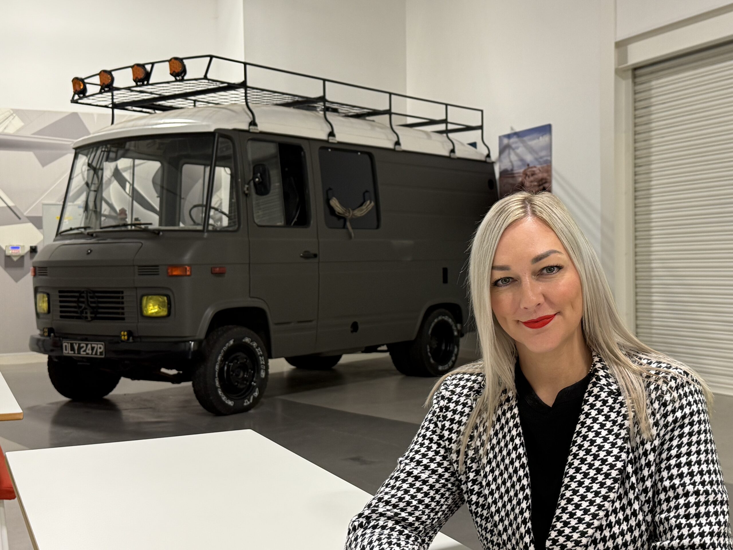 Image of natalis sitting in front of a custom van at the Progress Close Office